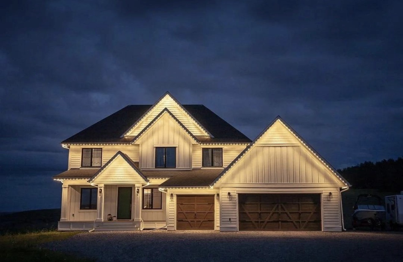 Upscale home illuminated with warm-white permanent architectural lighting