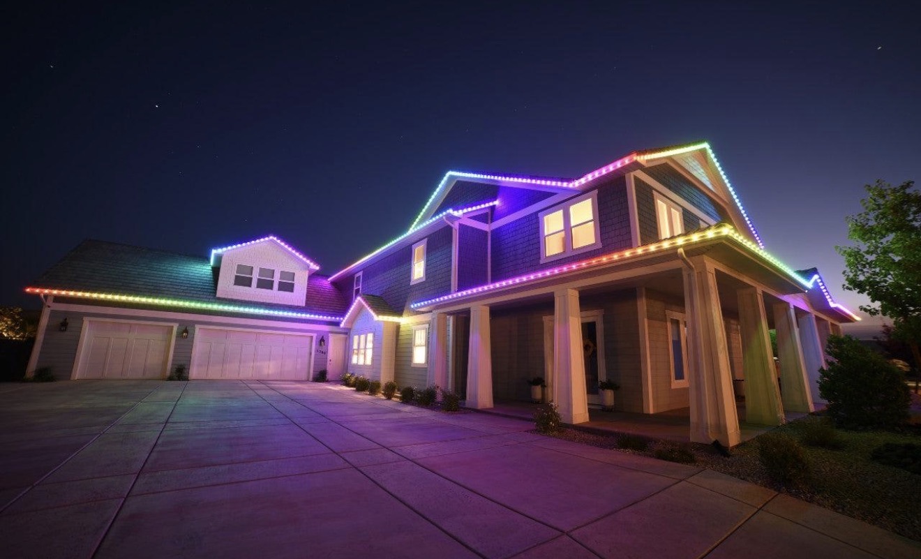 Large home displaying multiple colors with permanent exterior lighting