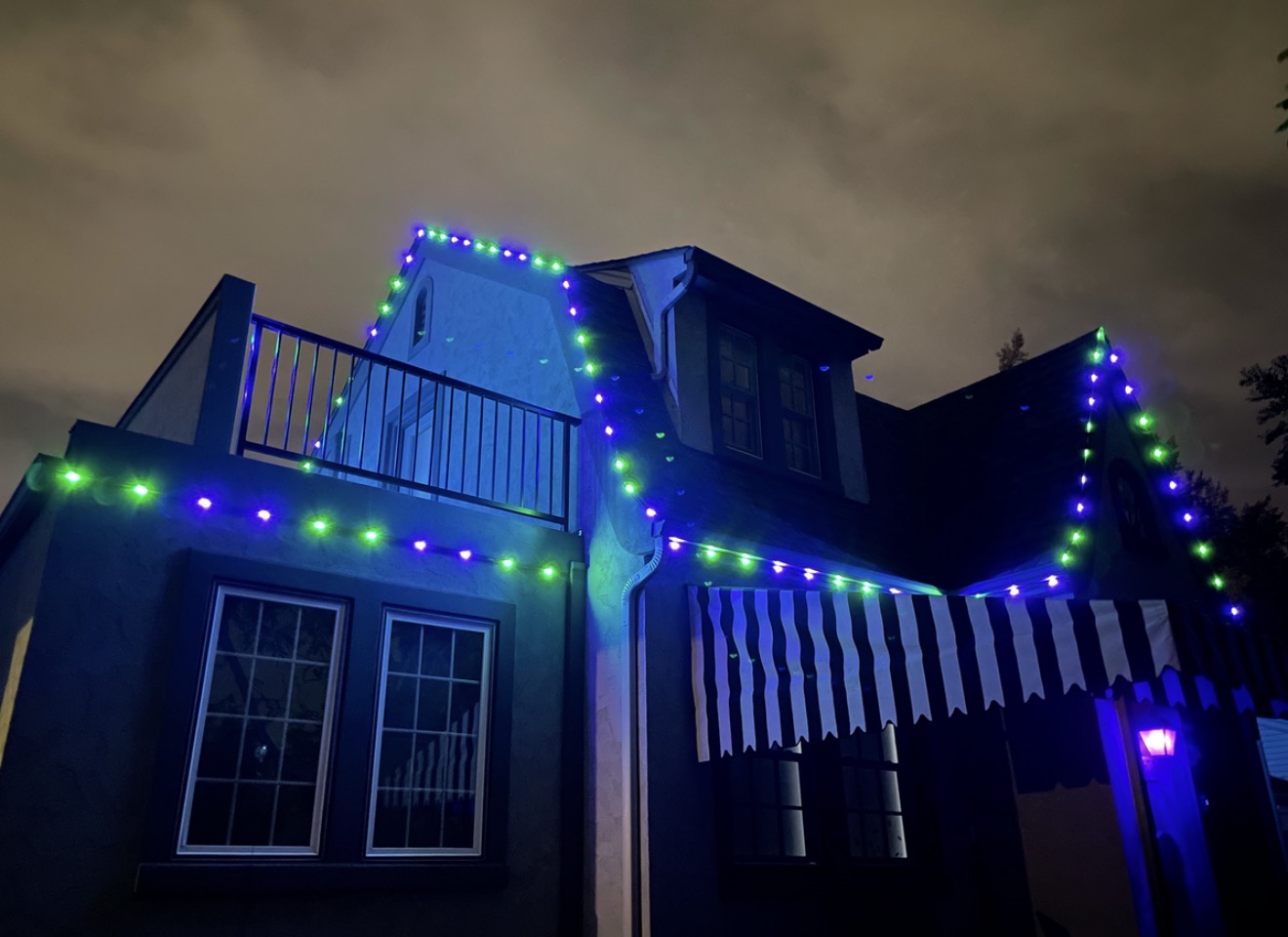 Home accented with blue and green permanent lighting for a special occasion